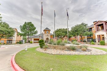 A building with a flag on top and a fire hydrant in front.